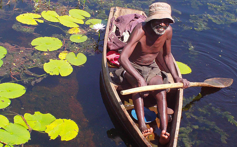 Man canoeing in wetland. PHOTO Uganda Conservation Foundation