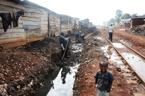 clearing rubbish from drainages Kampala slums