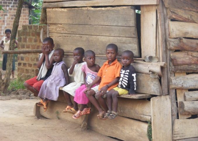 Row of children sitting at a duuka, Uganda