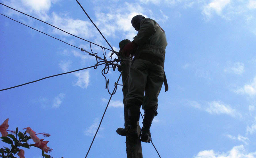 electricity disconnection Umeme worker up pole Kampala