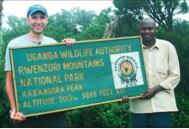 Abanya Rwenzori guide with tourist. Karangora Peak, Uganda hike