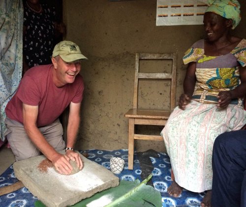 Roger gets his hands dirty. Making millet flour on Agartha's Taste of Uganda Tour