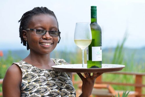 maggie serves wine. Isunga Lodge Kibale Forest Uganda