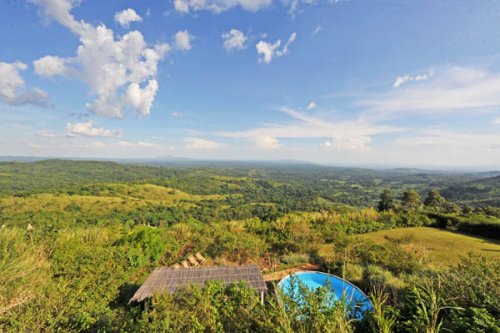 view and splash pool, morning over Kibale Forest Isunga Lodge Uganda
